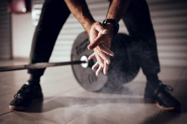 close up strong man s hands with talc getting ready weightlifting garage gym