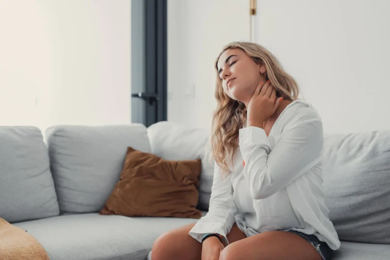 close up tired woman massaging neck muscles after long sedentary work exhausted girl feeling